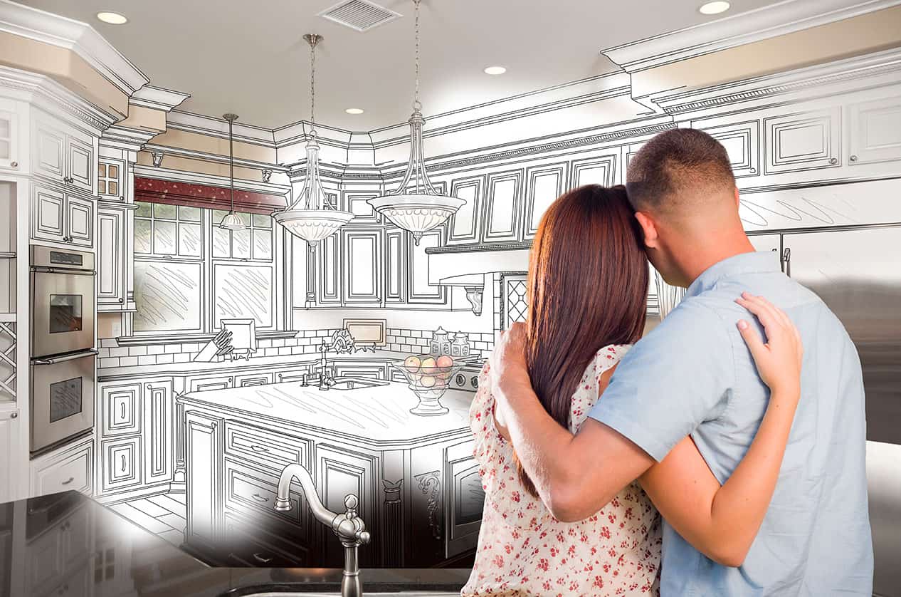 Man and woman looking a the blueprints of their kitchen lighting plan.